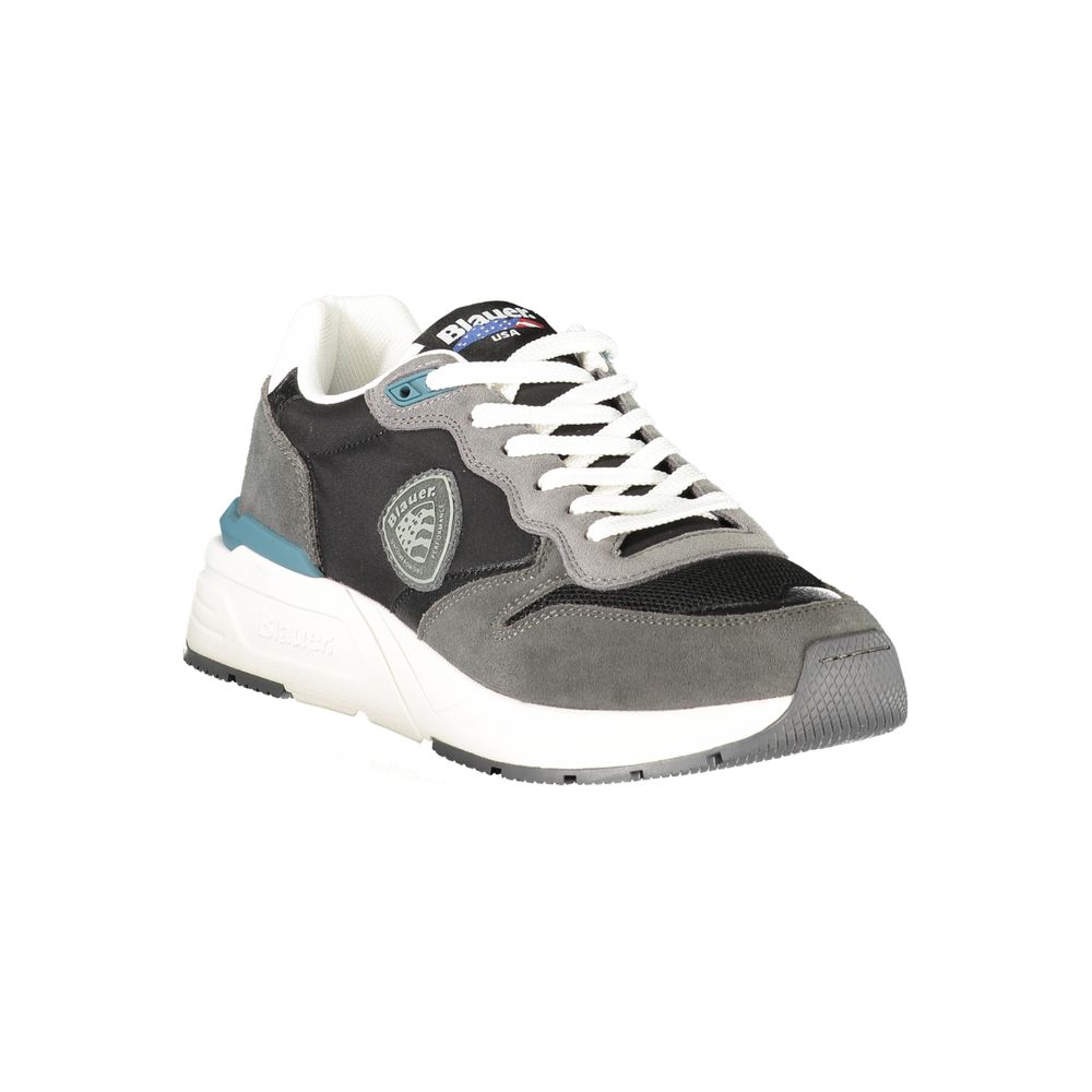 A black and white sneaker with a teal stripe on the side, featuring a circular logo on the tongue