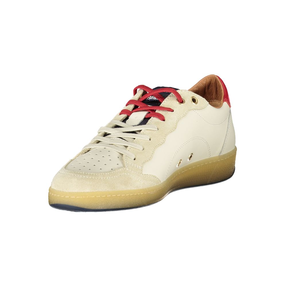 A white sneaker with red laces and a tan sole
