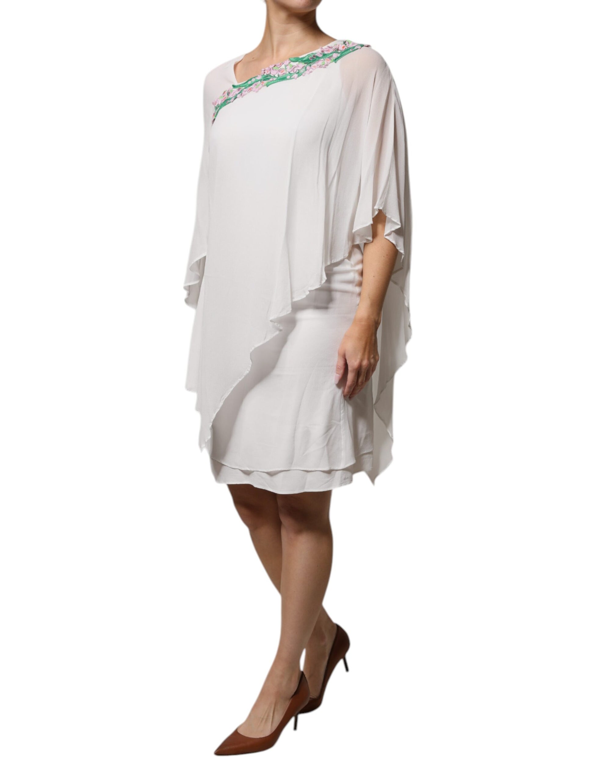 A white chiffon dress with floral embroidery and a V-neckline