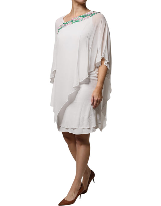 A white chiffon dress with floral embroidery and a V-neckline