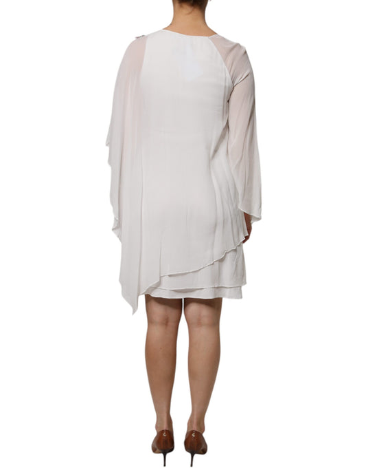 A white chiffon dress with floral embroidery and a shift silhouette