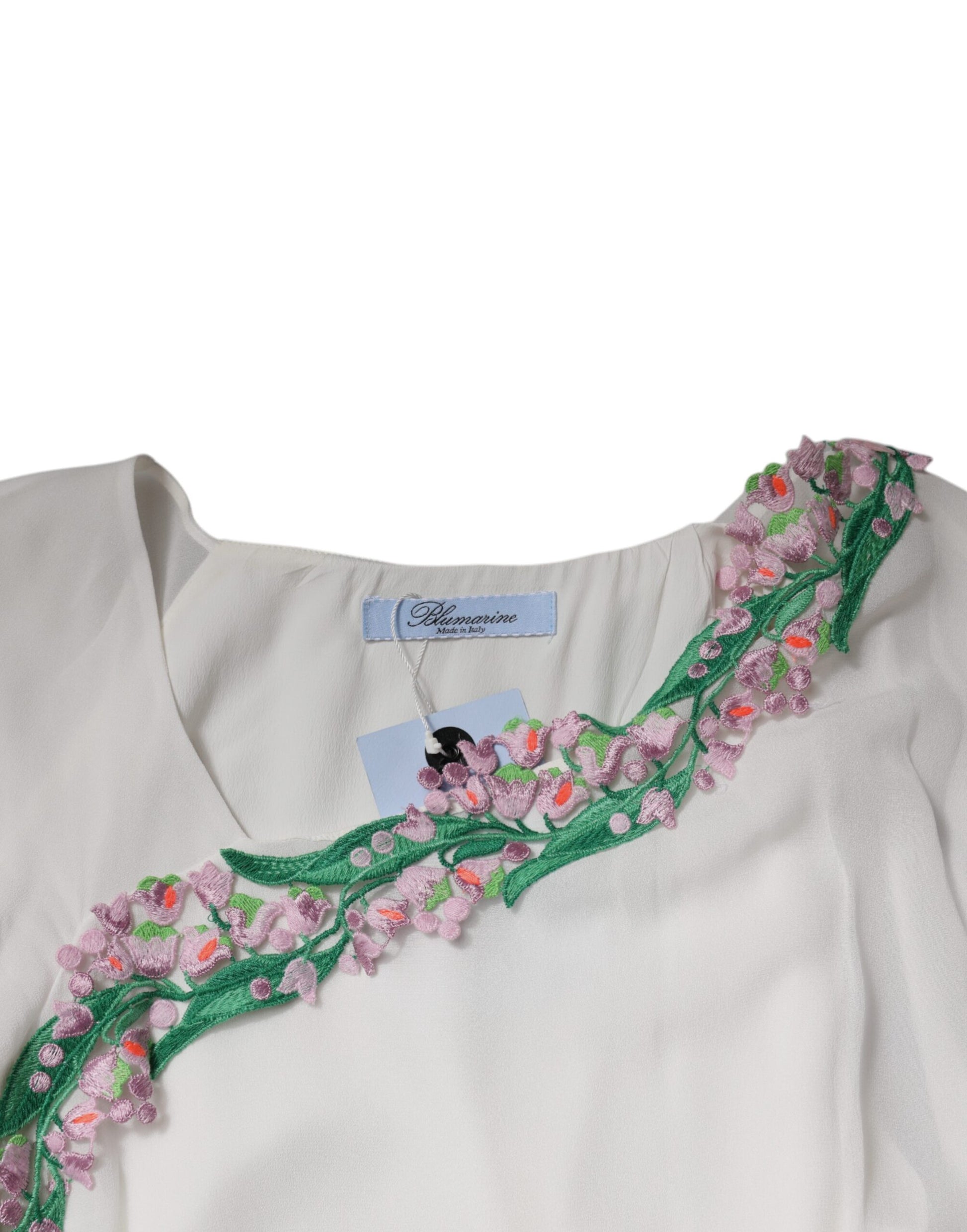 A white dress with floral embroidery and a chiffon skirt