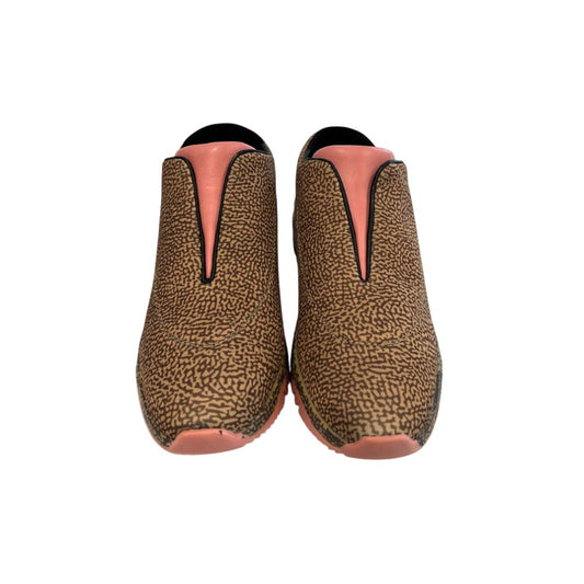 Pair of women's leather sneakers with pink accents and a patterned design