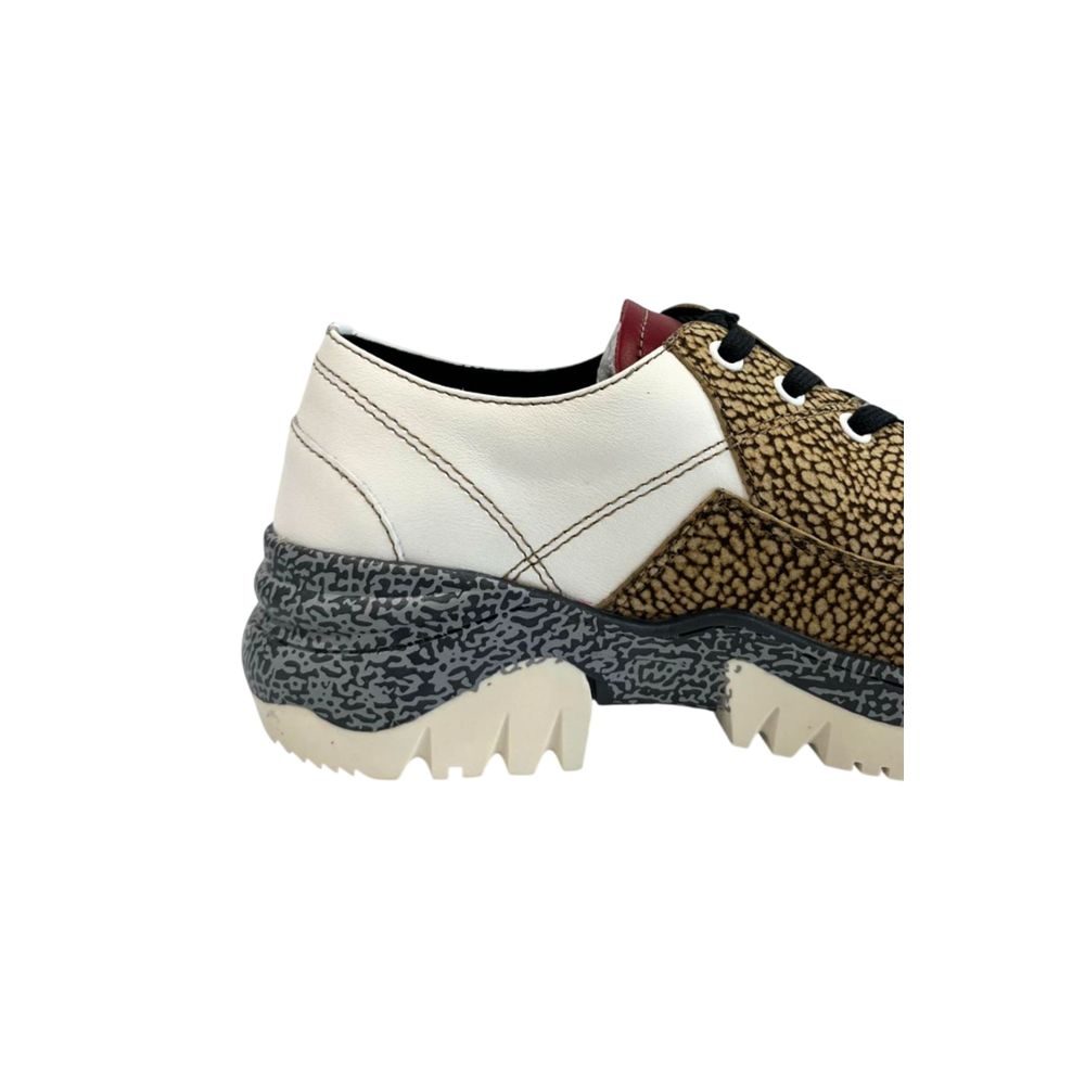 A beige leather women's sneaker with white laces, a black sole, and a patterned design on the side