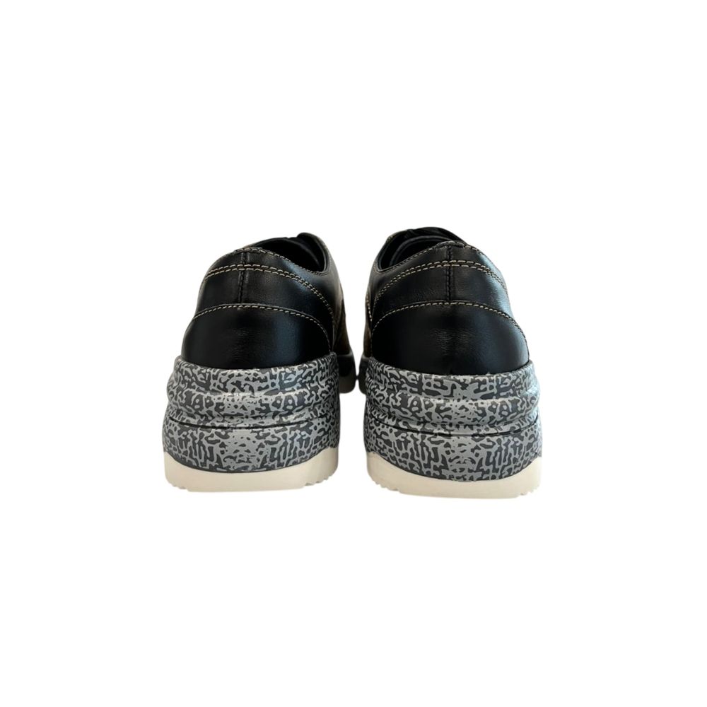 Pair of black and white women's sneakers with beige soles