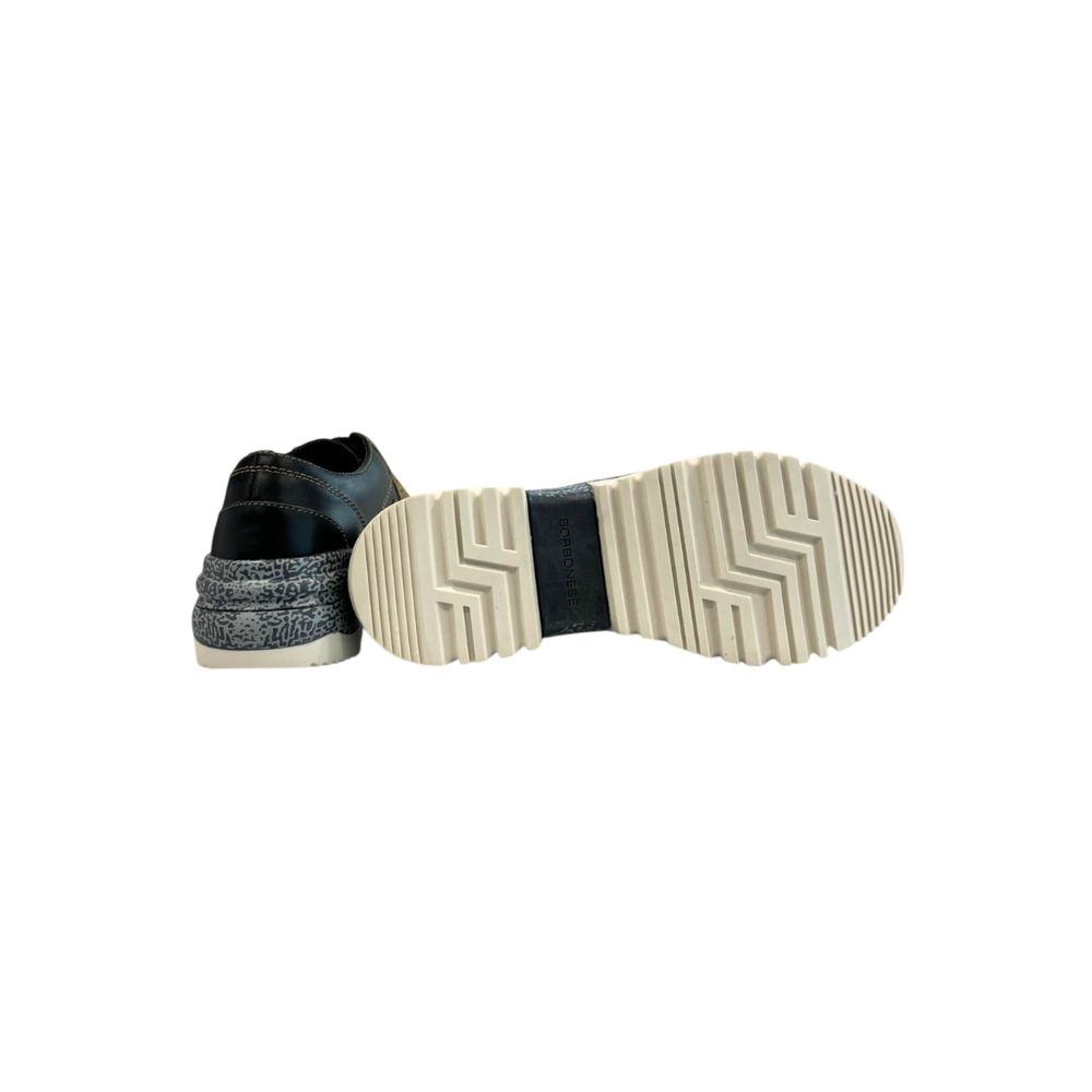 A single shoe with a beige leather upper, black laces, and a white sole