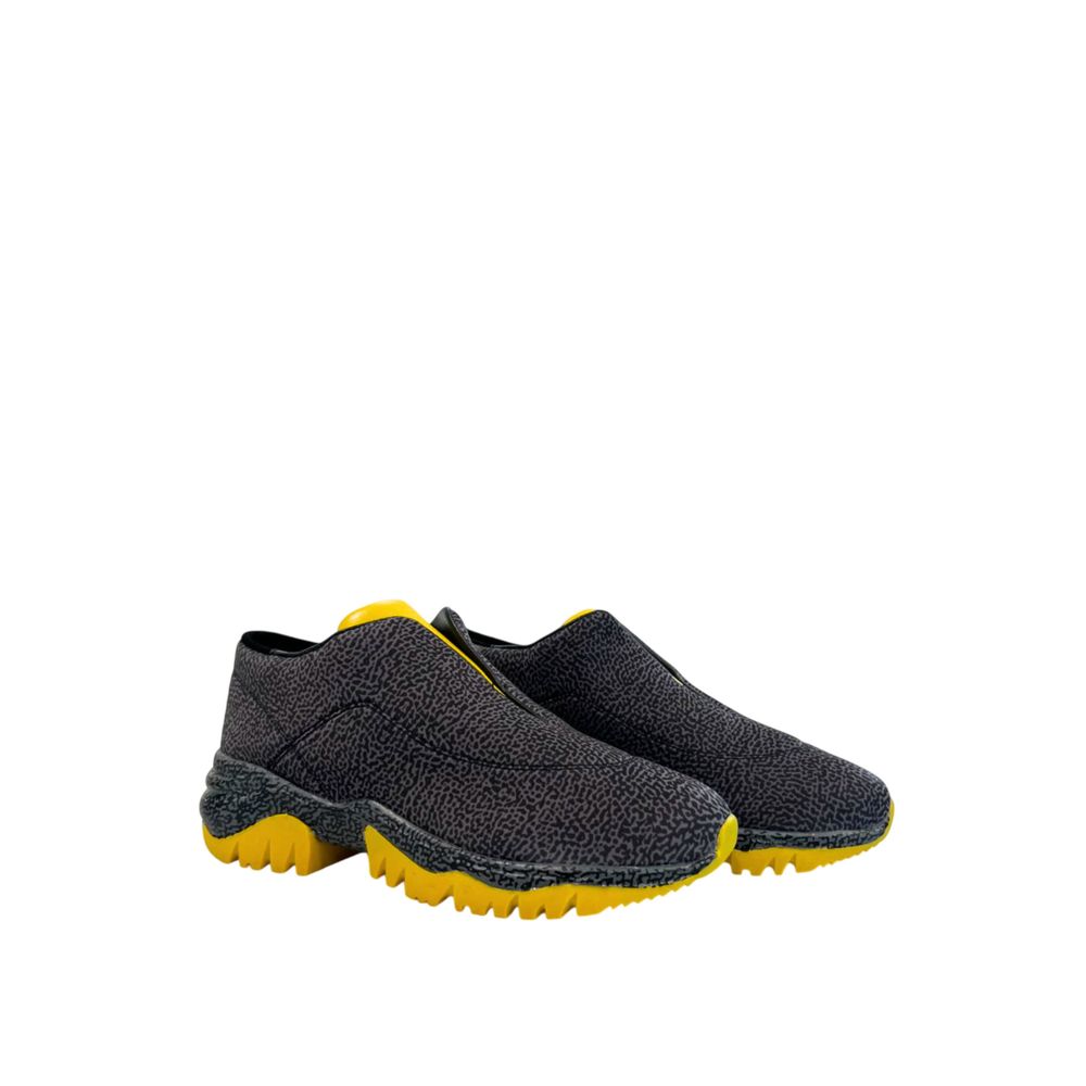 A pair of black leather women's sneakers with yellow accents, featuring a textured upper and rubber soles