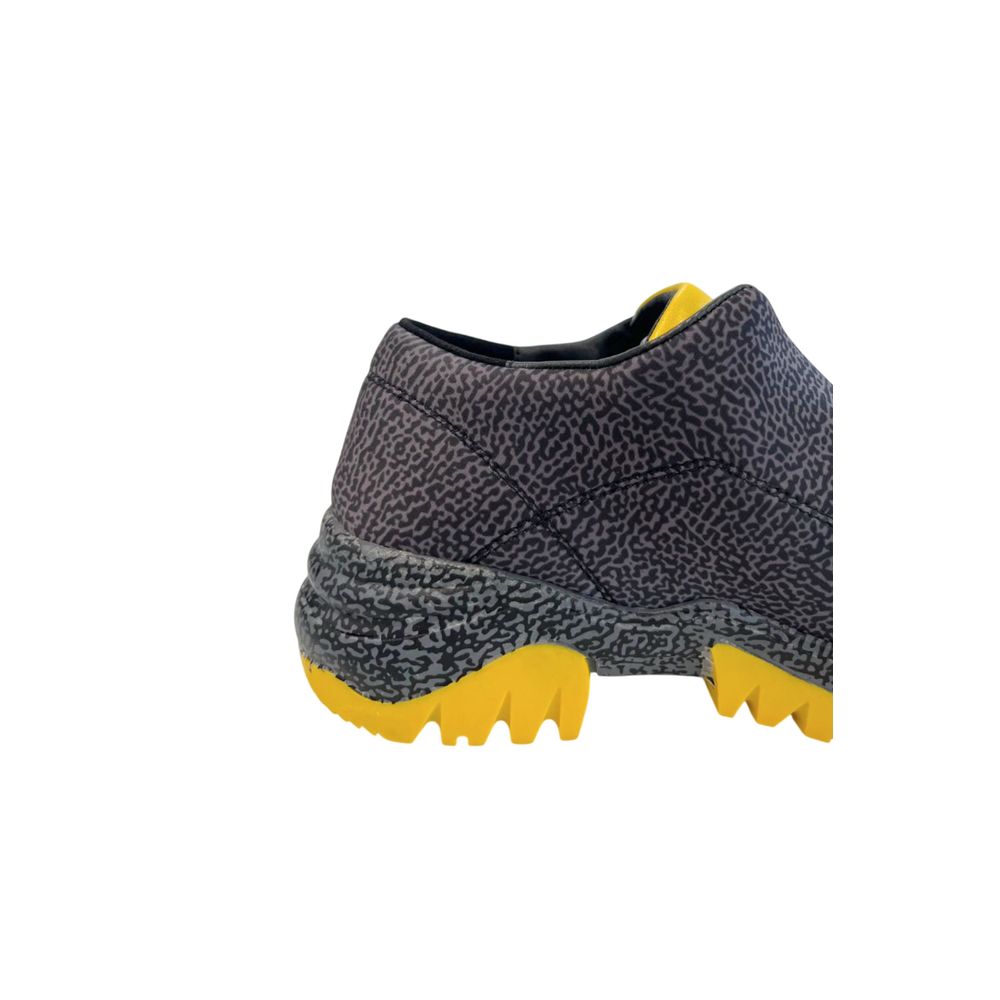 A black leather women's sneaker with yellow accents