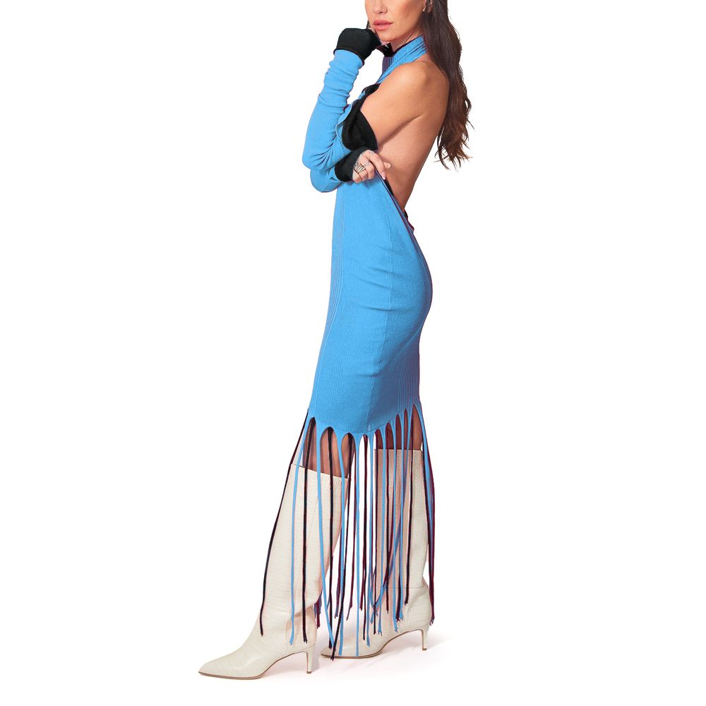 A woman wearing a blue dress with fringe details, paired with knee-high boots