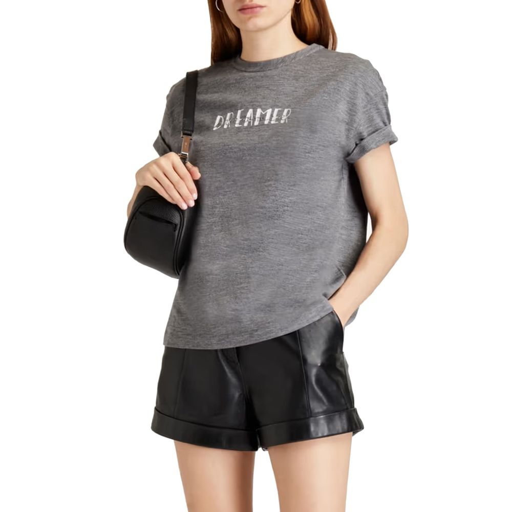 Woman wearing gray t-shirt and black leather shorts