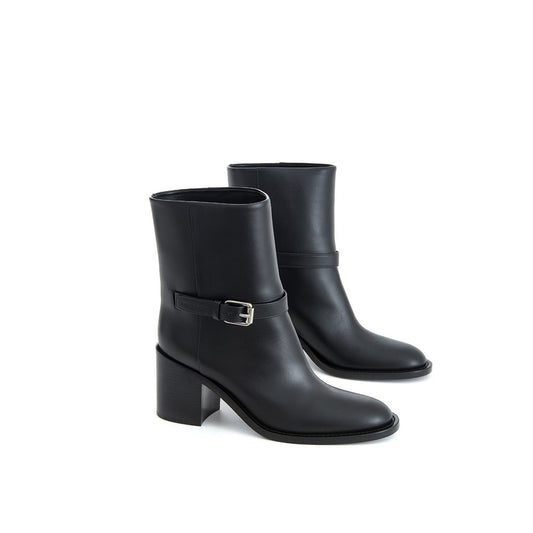 Pair of black leather boots with a buckle on the side