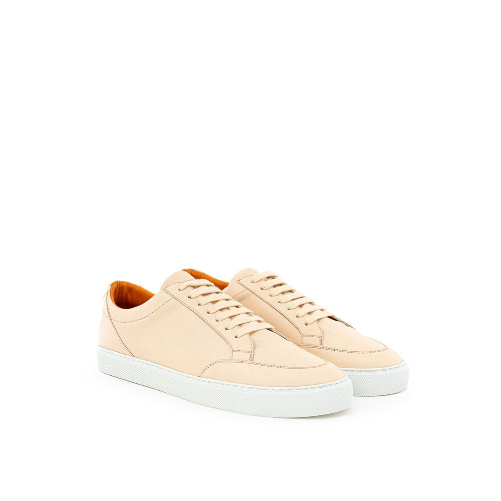 Pair of beige sneakers with white soles and laces