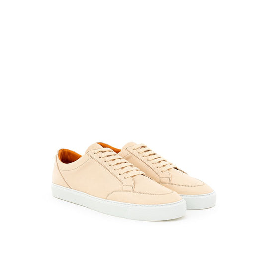 Pair of beige sneakers with white soles and laces