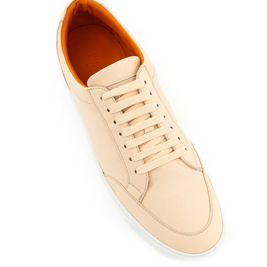 Tan canvas sneaker with white sole and laces