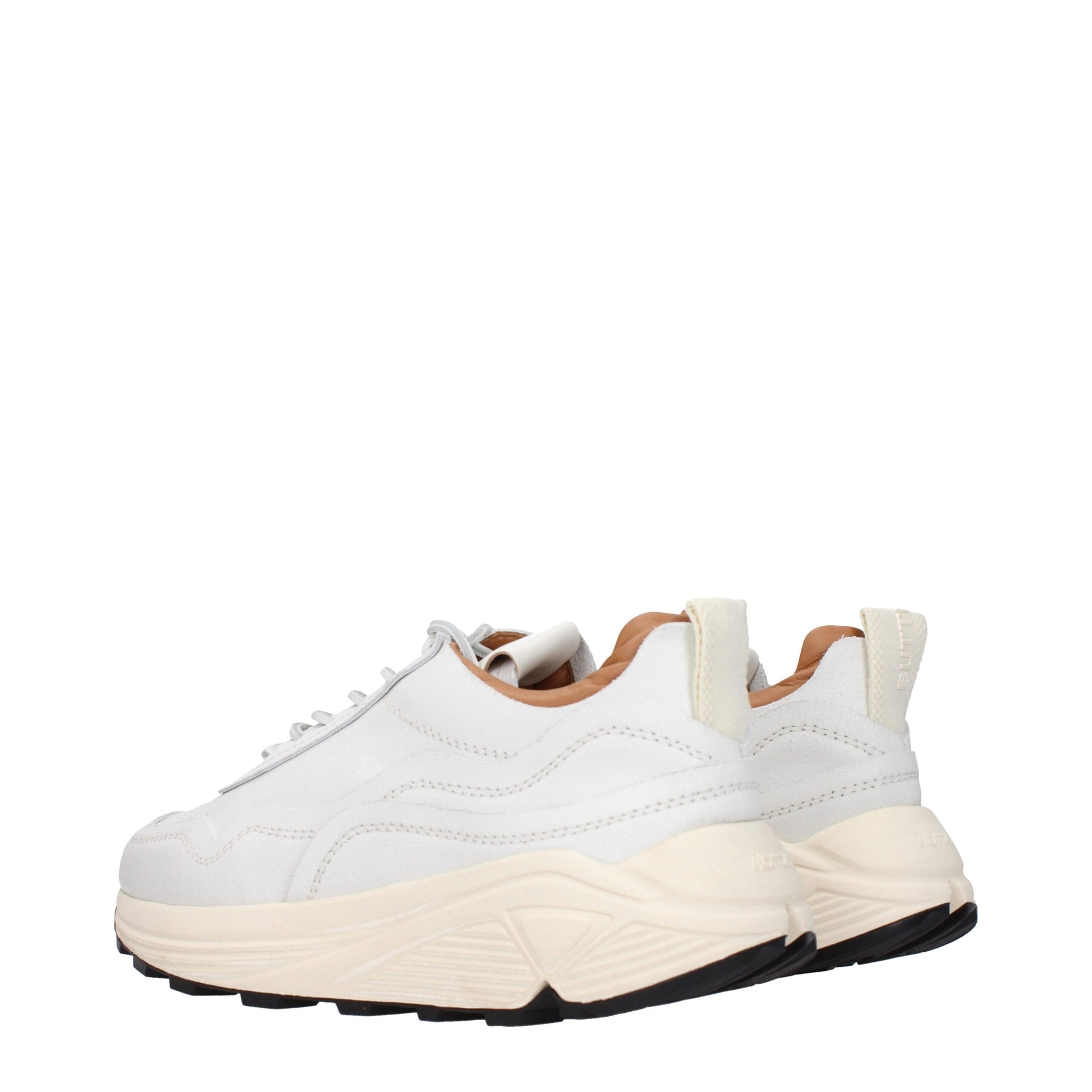 A pair of white chunky sneakers with tan accents