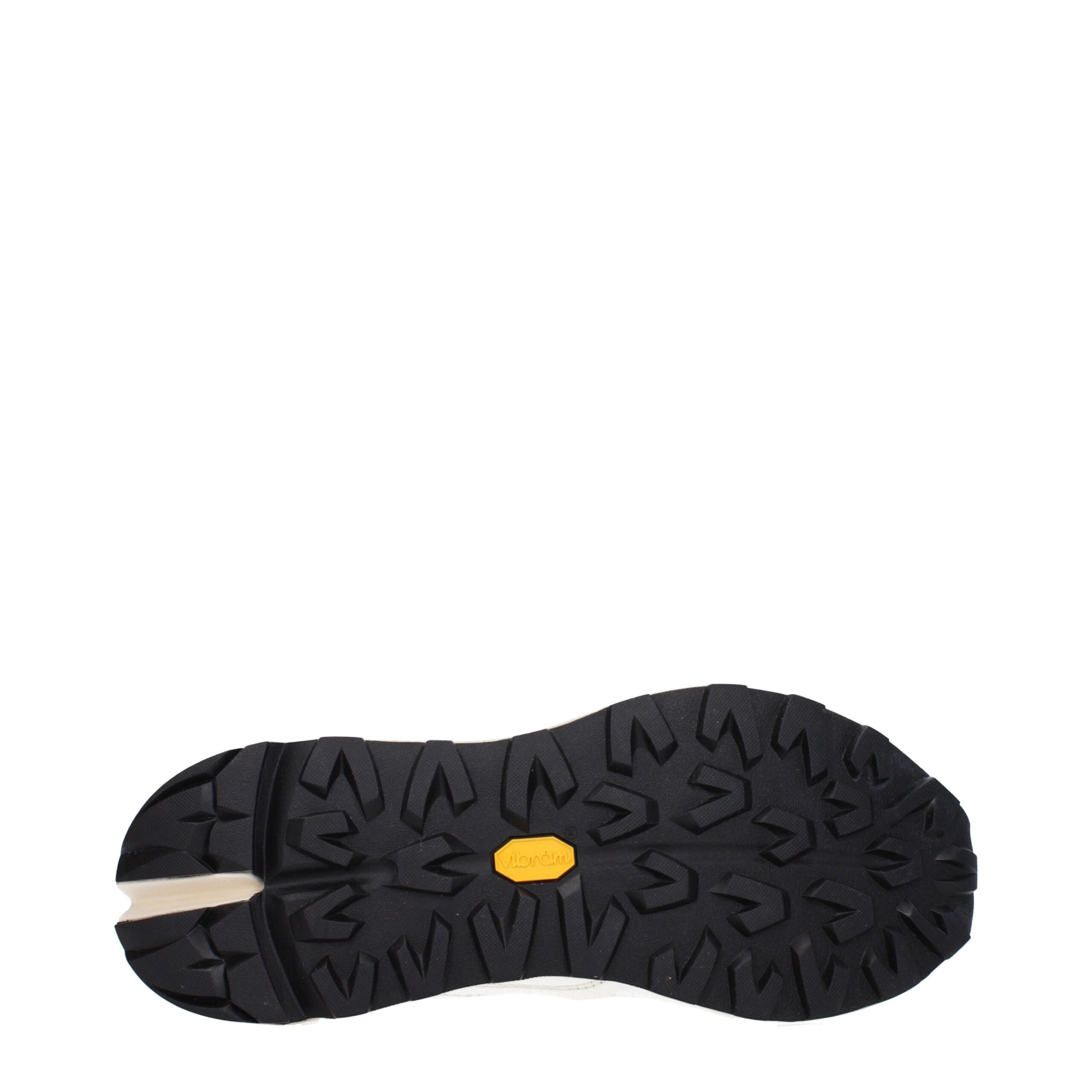 Pair of black and white sneakers with yellow logo on sole
