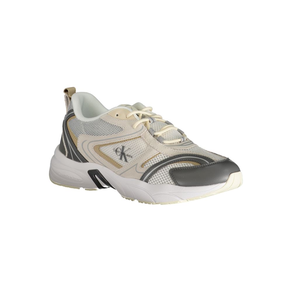 A beige men's sneaker with a black sole, featuring a logo on the side and laces for closure
