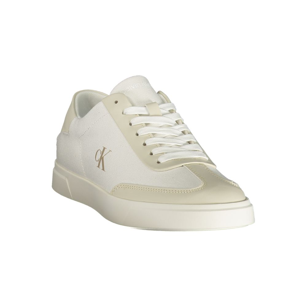A woman's white sneaker with a lace-up front, featuring a logo on the side and a flat sole