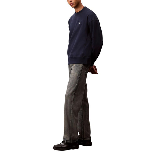 Man wearing blue sweater and jeans