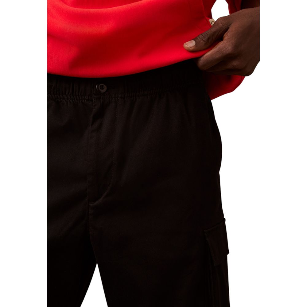 Man wearing black pants and red shirt