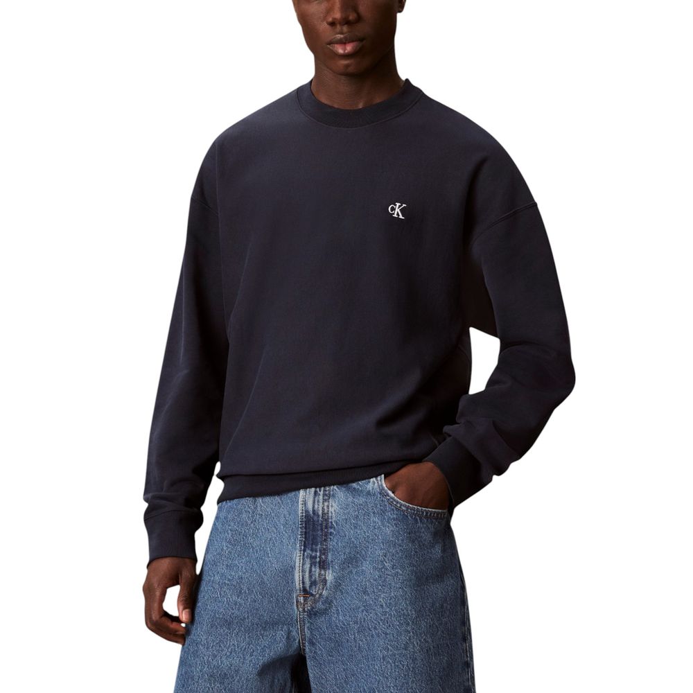 Man wearing blue sweatshirt and jeans