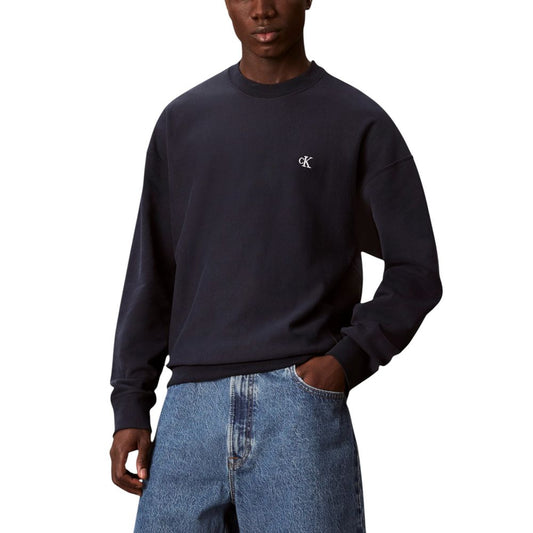 Man wearing blue sweatshirt and jeans