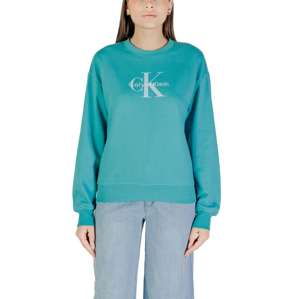 Woman wearing blue sweatshirt with white logo