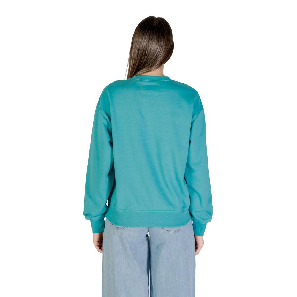 Woman wearing blue sweatshirt and jeans