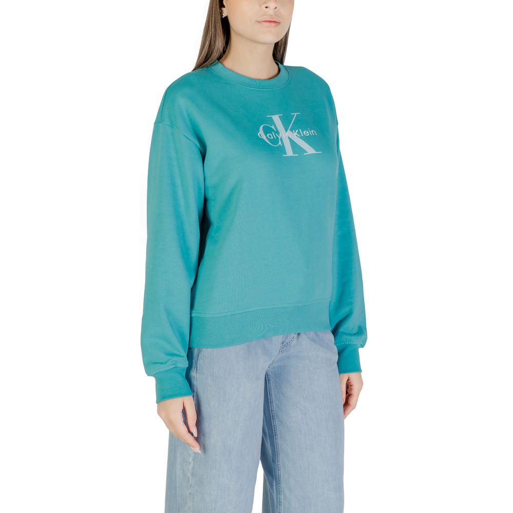 Woman wearing blue sweatshirt with white logo