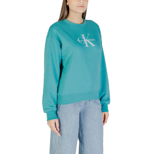 Woman wearing blue sweatshirt with white logo