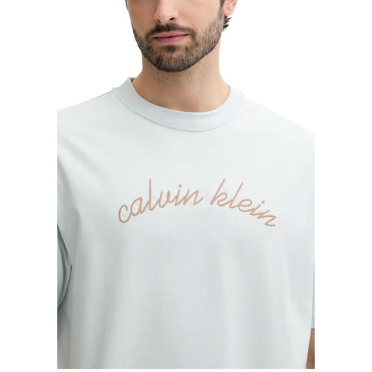 Man wearing white t-shirt with calvin klein logo in beige color