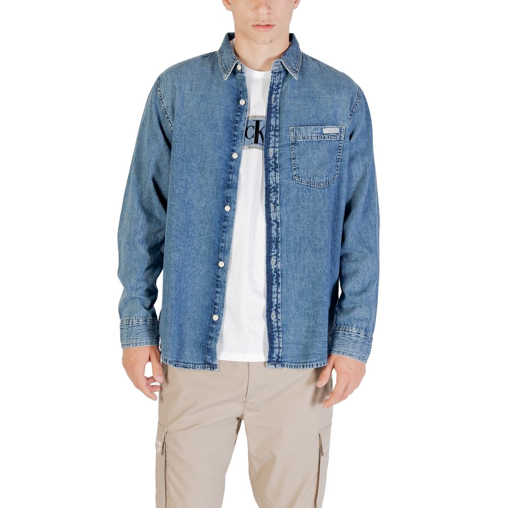 Man wearing blue denim jacket over white t-shirt
