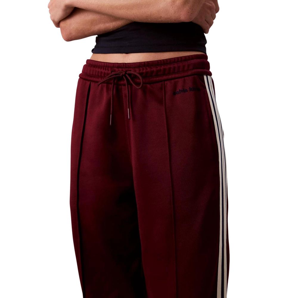 Pair of red sweatpants with white stripes on sides