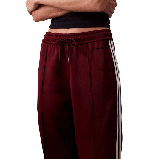 Pair of red sweatpants with white stripes on sides