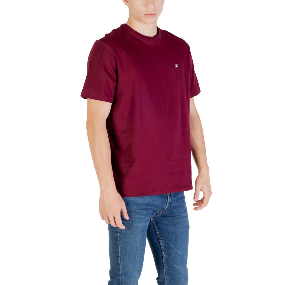 A mannequin wearing a red t-shirt with a white logo on the left chest area