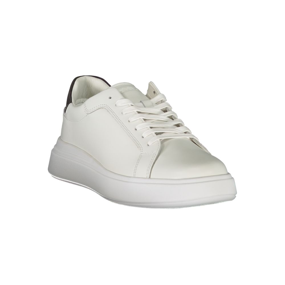A white leather men's sneaker with a lace-up front, featuring a flat sole and a minimalistic design