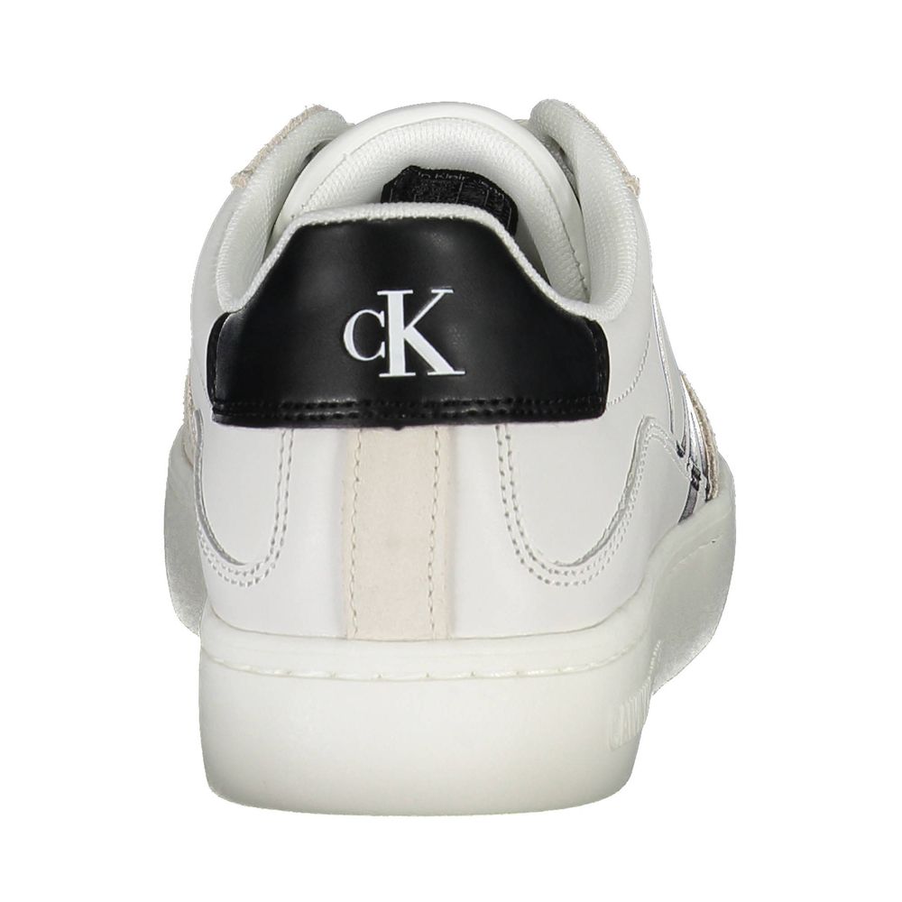 A white leather women's sneaker with a black logo on the side, featuring a lace-up closure and a flat sole