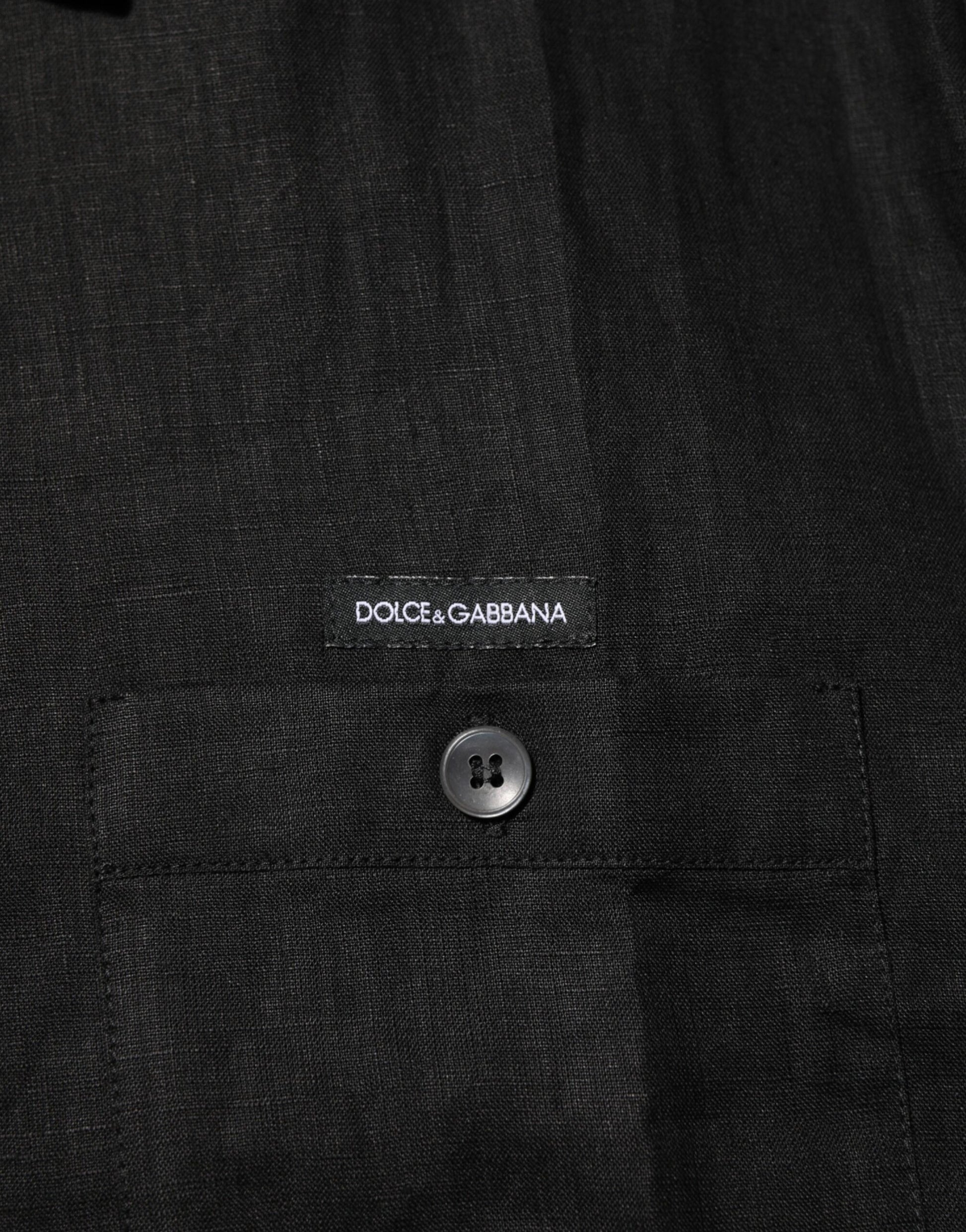 A close-up view of a garment with visible stitching details. There is a button on the right side of the image