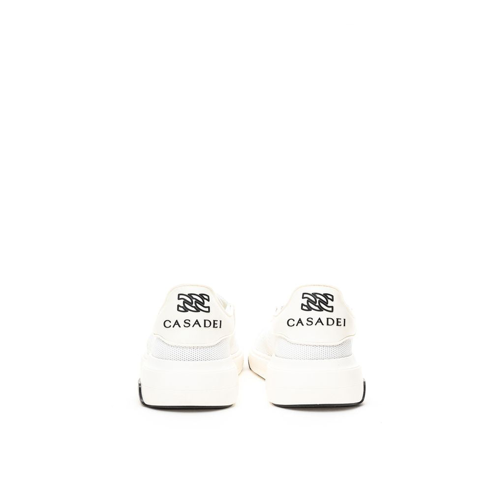 Pair of white sneakers with black laces and a logo on the side