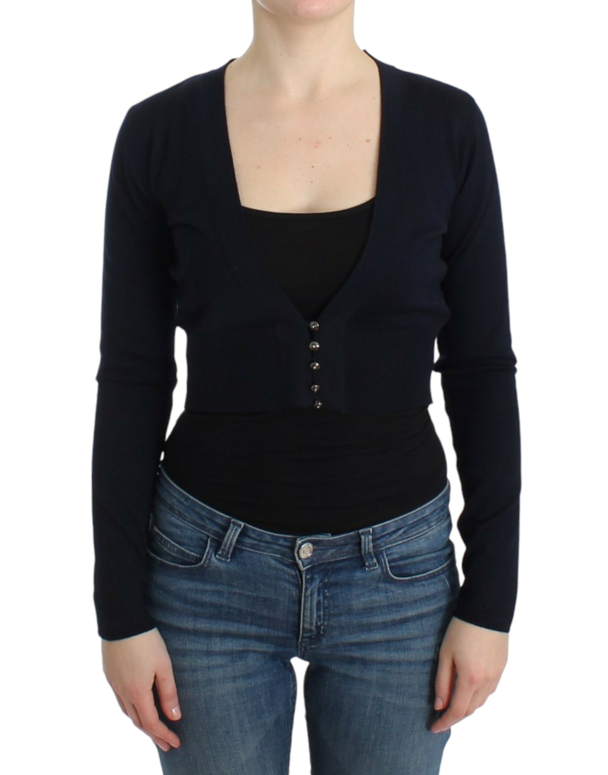Woman wearing black sweater over black tank top and blue jeans