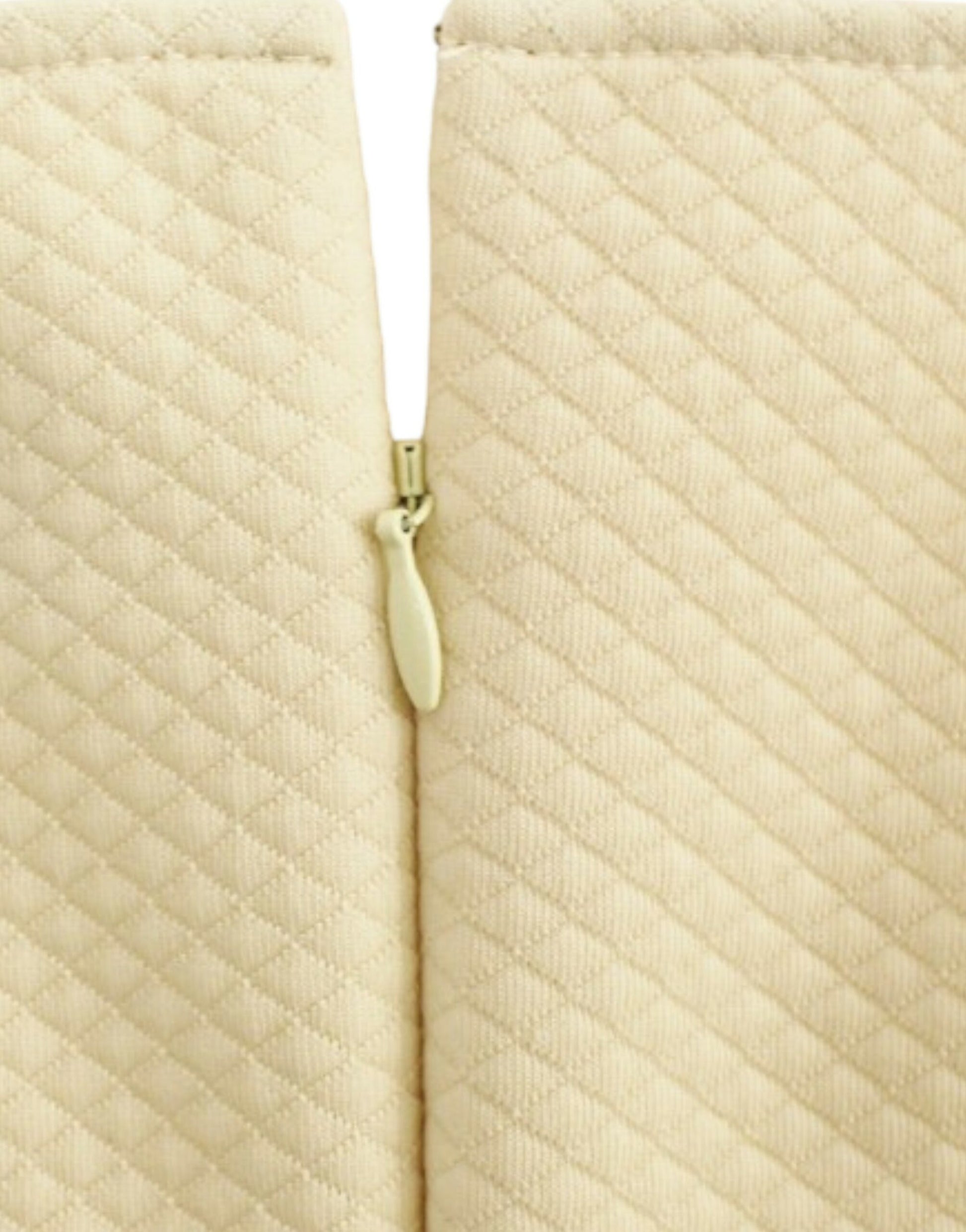Closed tan fabric curtains with a gold zipper pull