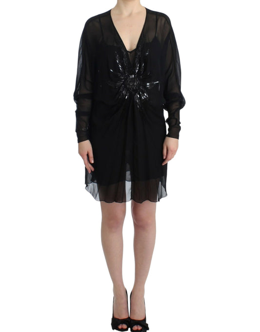 Black dress with long sleeves and embellishments on bodice