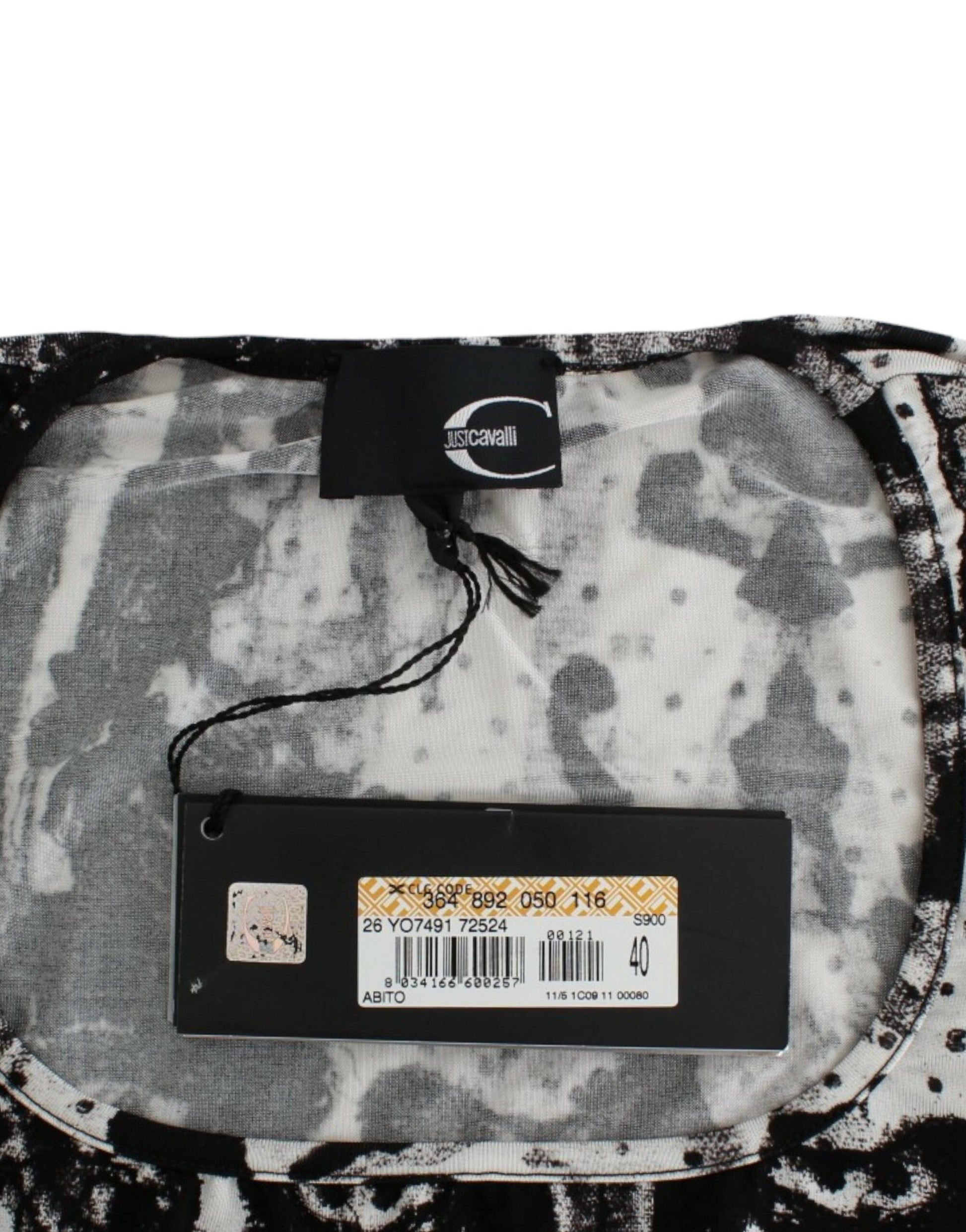 Black tag on a gray and white patterned fabric item