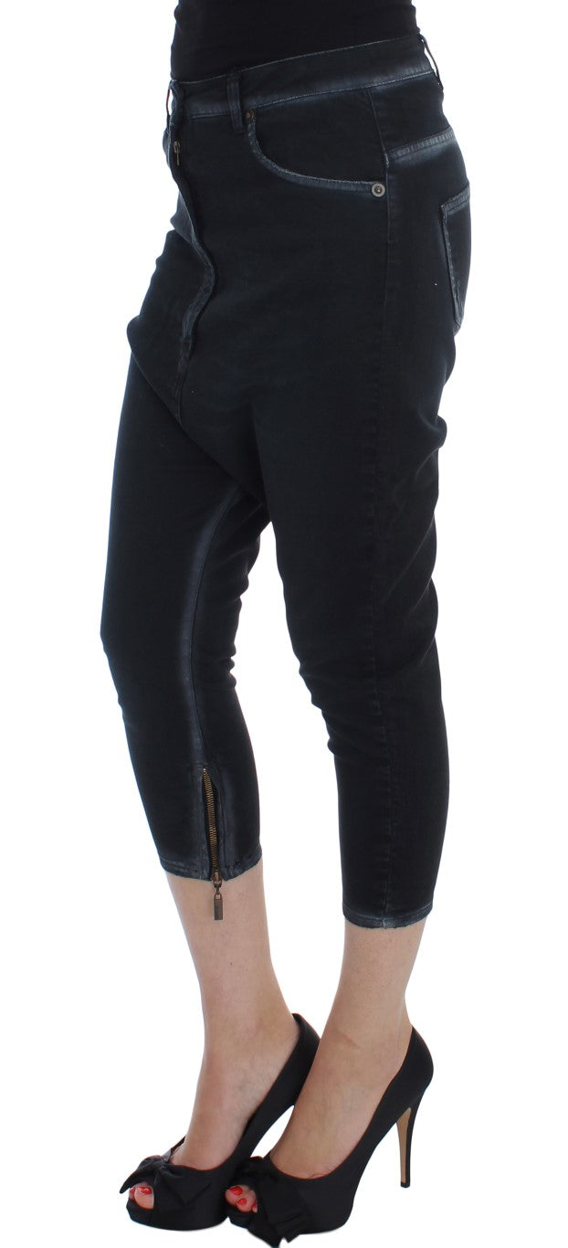 Pair of black skinny jeans with zipper detail on legs and waistband