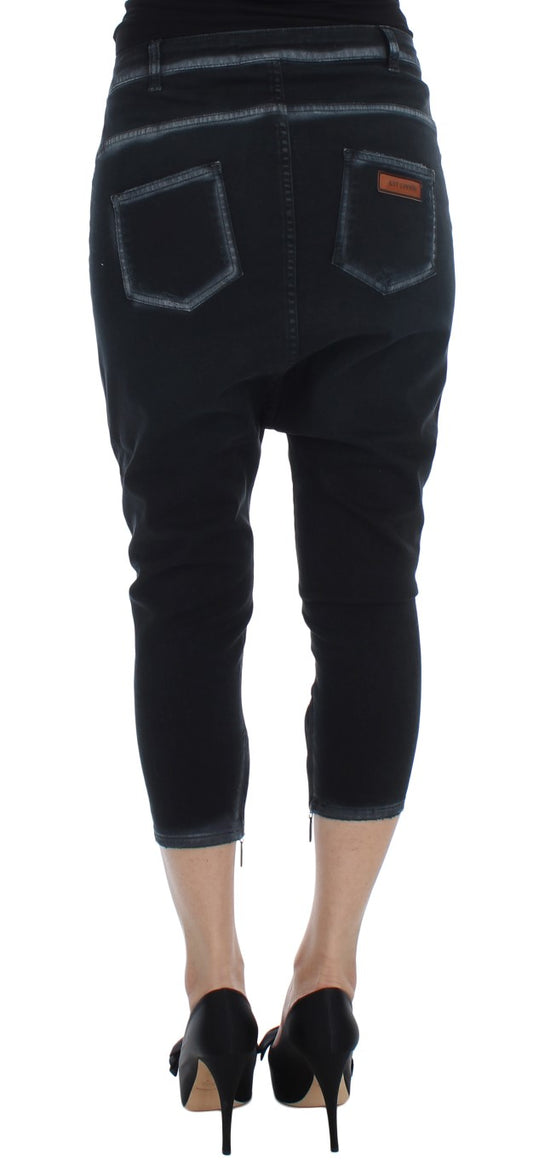 Pair of women's jeans with distressed design and rolled up legs