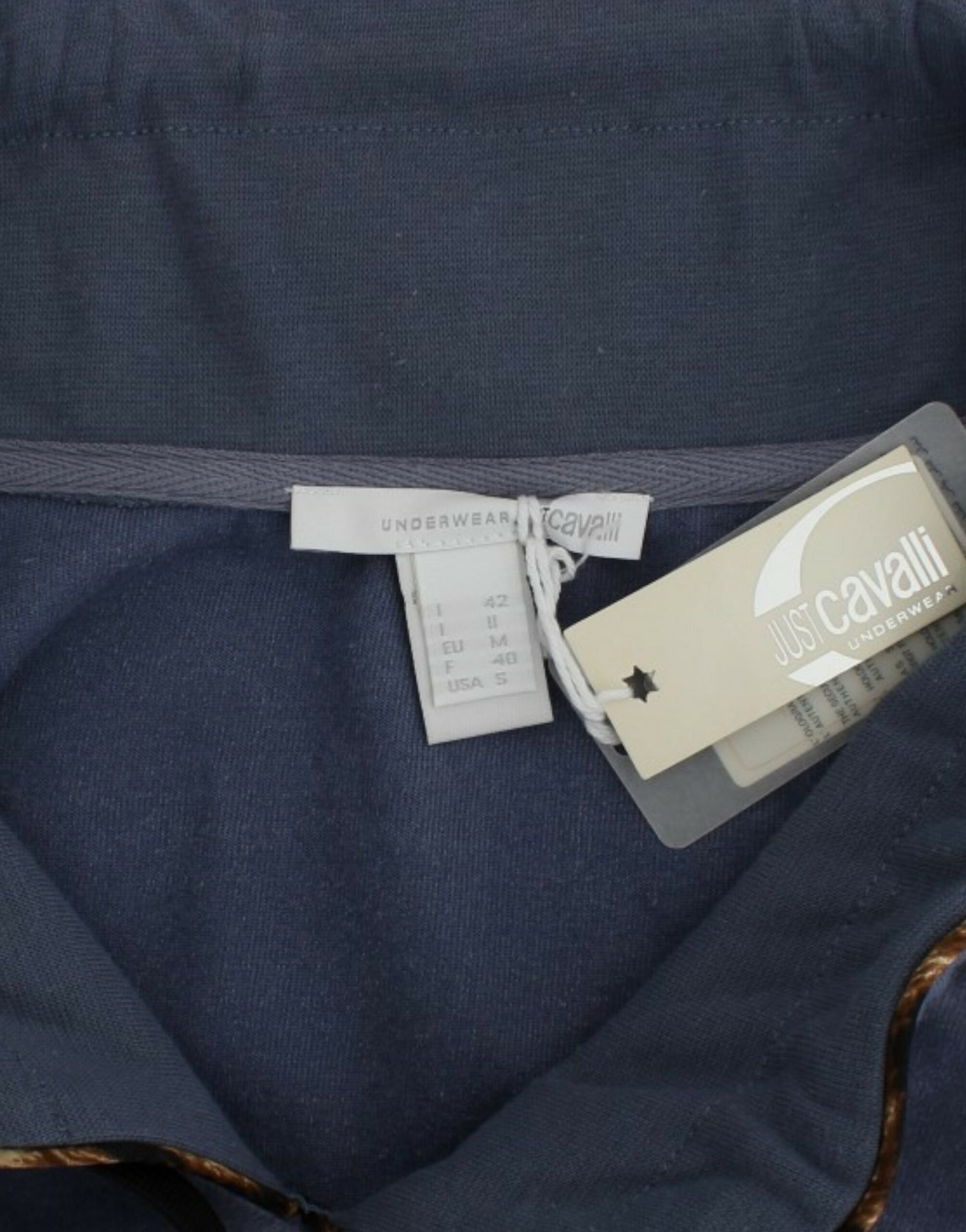 Blue shirt with tags attached to waistband