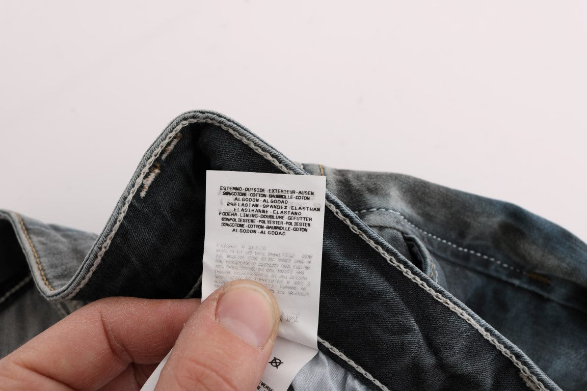 Hand holding a jeans tag