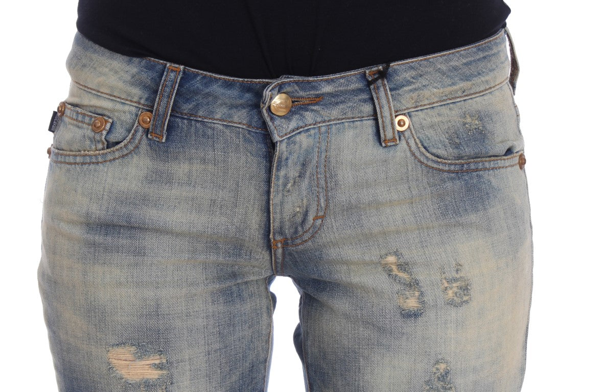 Pair of distressed denim shorts with button closure
