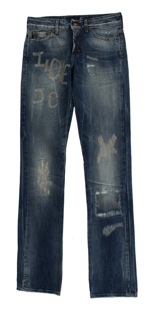 Pair of distressed blue denim jeans with faded areas and holes