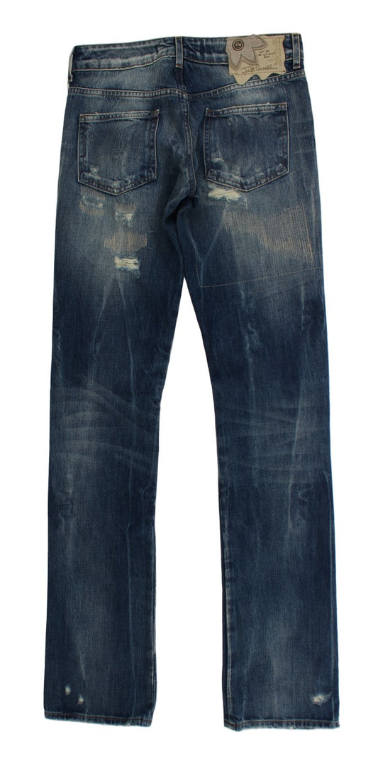 Pair of blue denim jeans with distressed areas and faded patches